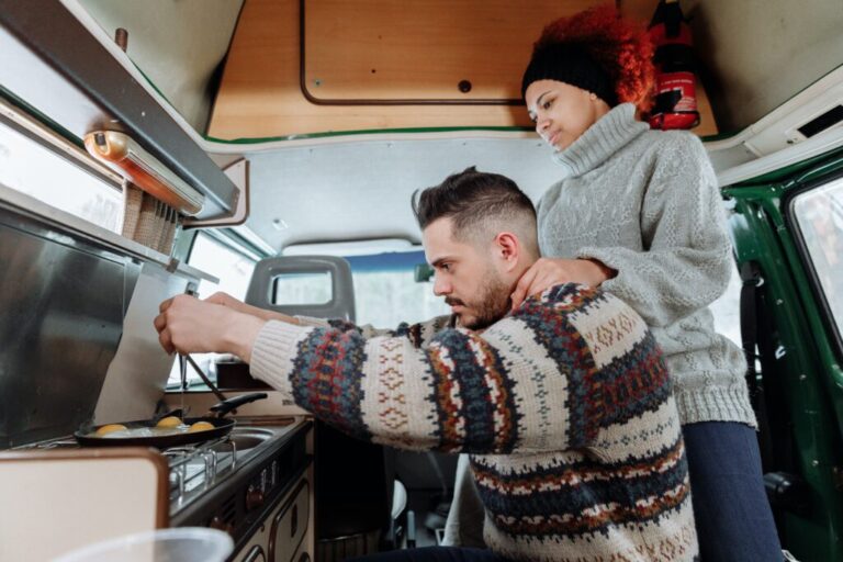 A Couple cooking breakfast in a campervan
